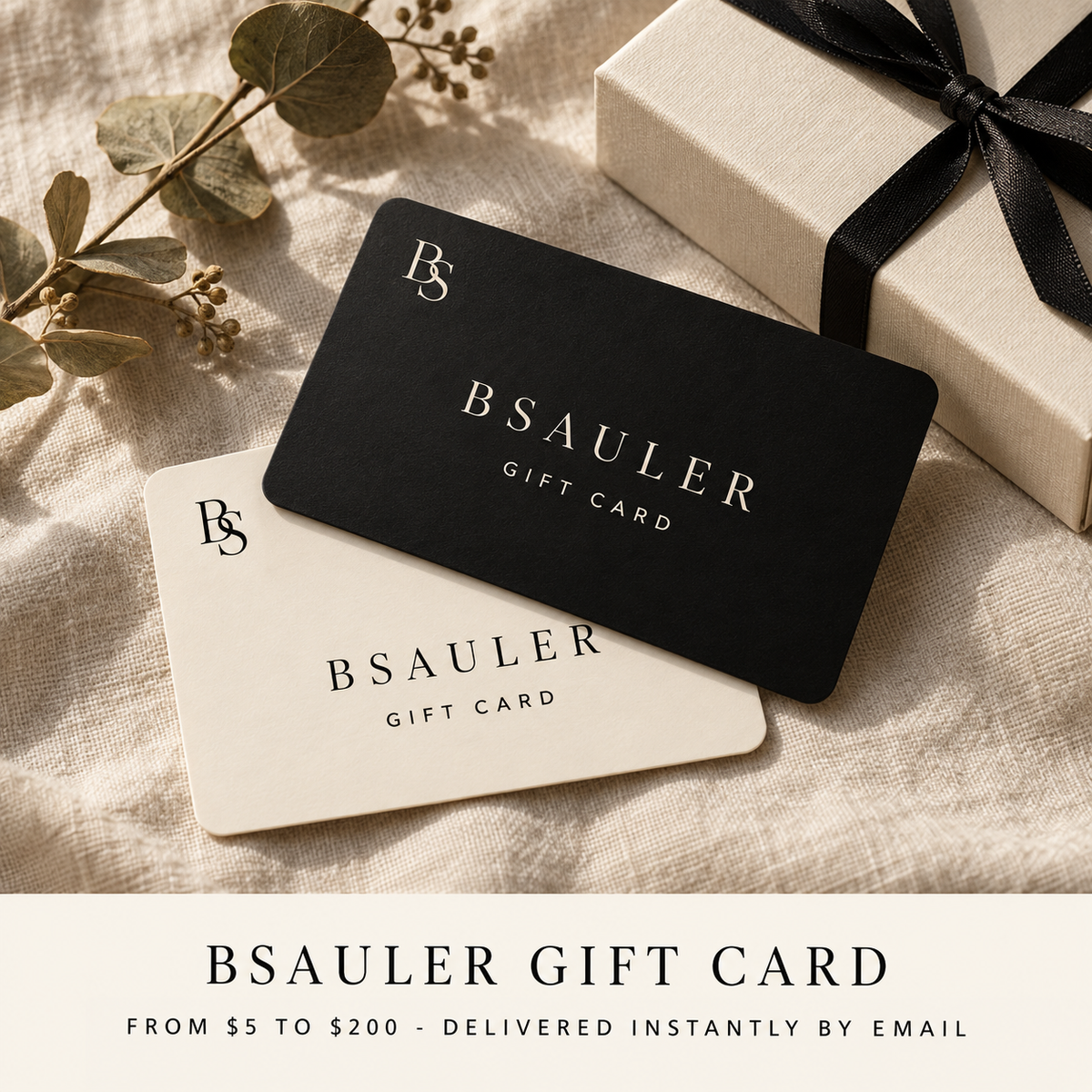 BSAULER gift card in black and cream on linen with a gift box